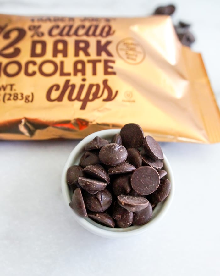 Bowl of Trader Joe’s 72% cacao dark chocolate chips beside the open bag