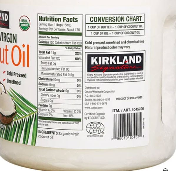 Back label of Kirkland Organic Virgin Coconut Oil showing Nutrition Facts and a butter-to-oil conversion chart