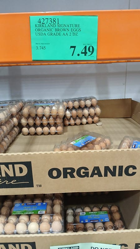 Costco display of Kirkland Signature organic brown eggs with a $7.49 price sign