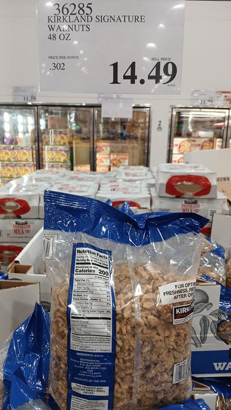 Costco display of Kirkland Signature walnuts, 48 oz, with a $14.49 price sign