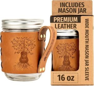 Oowee premium leather wide-mouth mason jar sleeve engraved with a guitar-and-tree design, shown with its 16 oz packaging