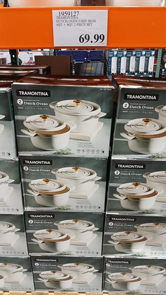 Costco display of a Tramontina two-piece enameled cast-iron Dutch oven set with a $69.99 price sign
