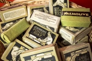 Basket of antique soap bars including Palmolive and Johnson’s pumice soap in aged paper wrappers