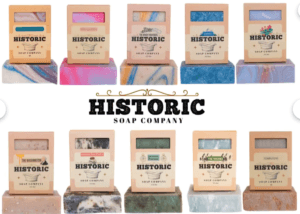 Historic Soap Company display of ten handmade soap bars in assorted colors with the company logo
