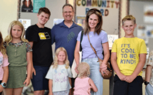 The author with his family and grandchildren posing together at a community event
